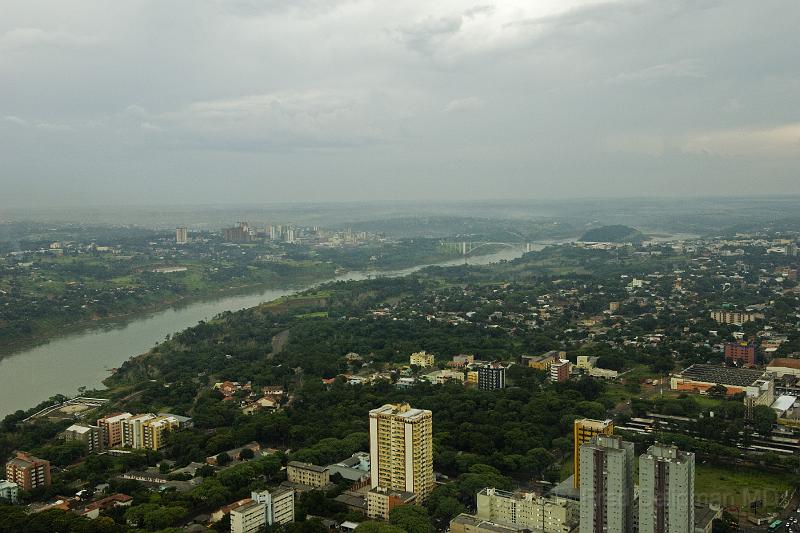 20071204_163046  D2X 4200x2667.jpg - Over the city of Foz Do Iguacu, Brazil which connects via the Friendship Bridge coming up ahead with the City of Cuidid del Este, Paraguay is on the left,  This is the more busy commercial bridge of Foz Do Iguacu. Foz Do Igacu, Brazil population is over 300,000.  It has the largest mosque outside the Middle East.  It has a diverse ethnic composiiton with more Chinese (25,000) than Muslims (20,000).  It was thought to be a source of funding for 9/11 but this did not turn out to be the case